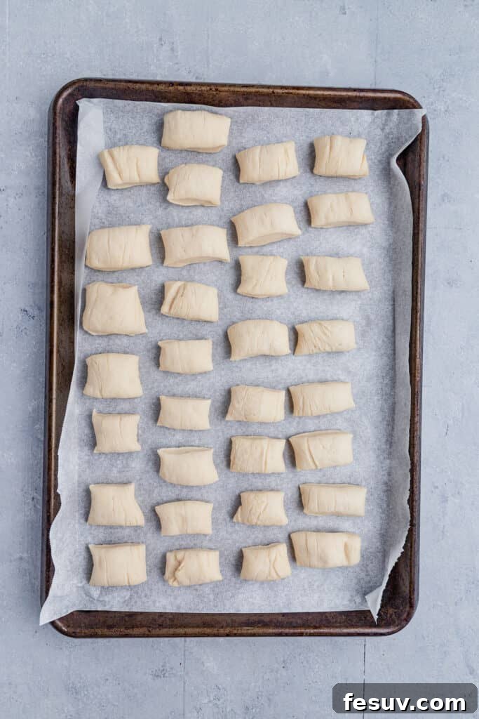 Small, uniform pieces of cut pretzel dough, ready for baking.