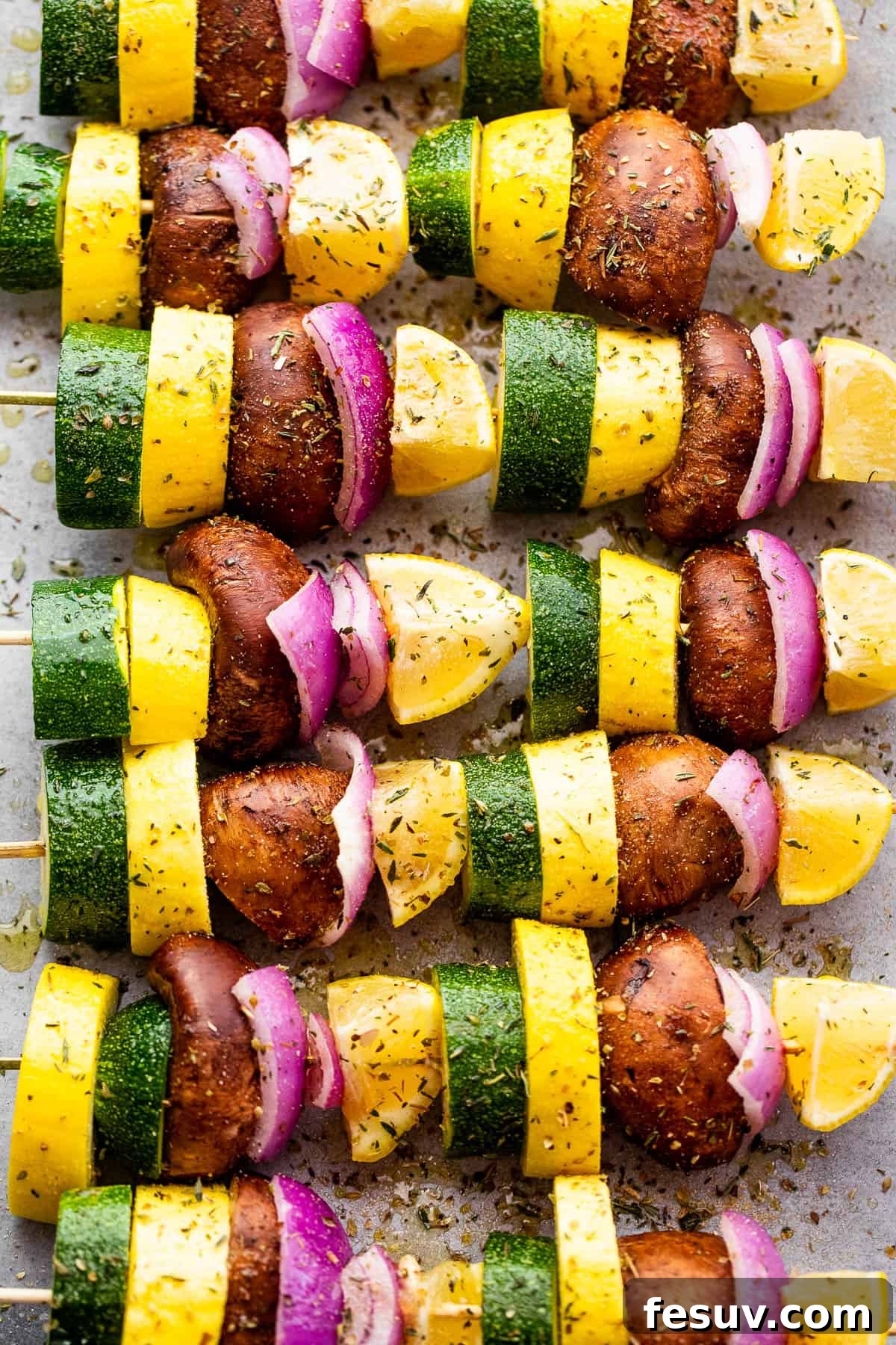Garden Fresh Grilled Squash Skewers 4 Eight individual skewers loaded with zucchini, yellow squash, red onion, mushrooms, and lemon, ready for grilling.