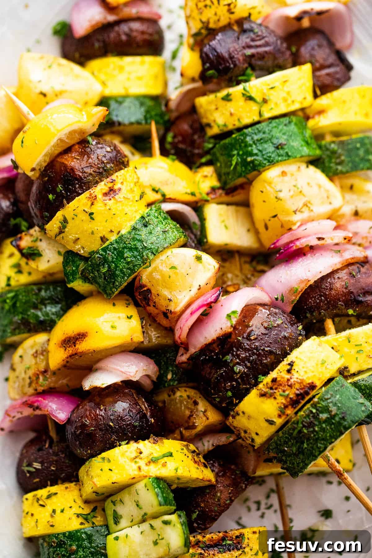 Garden Fresh Grilled Squash Skewers 5 Close-up side view of grilled summer squash kebabs on a plate, showing the tender vegetables and lemon slices.