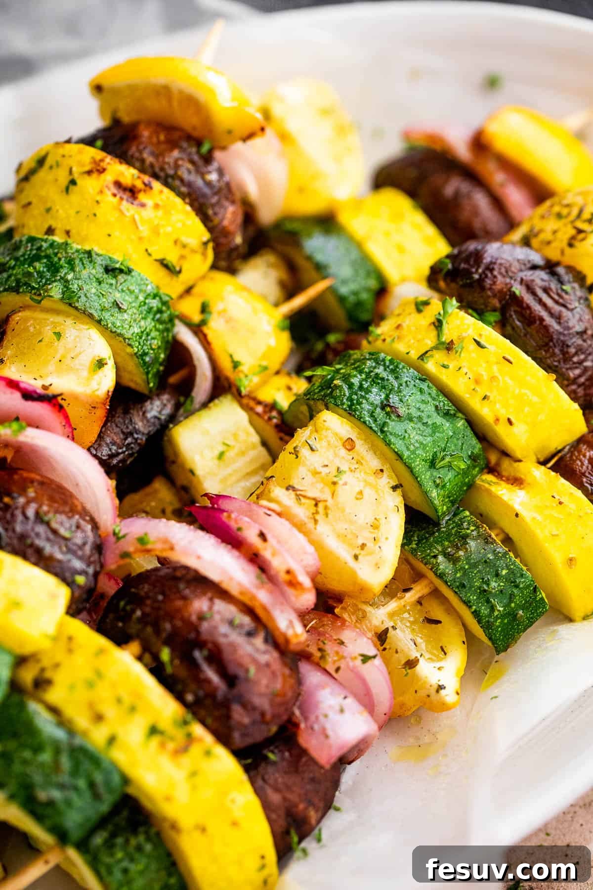 Garden Fresh Grilled Squash Skewers 6 Side angle view of plated grilled summer squash kebabs with a vibrant mix of vegetables.