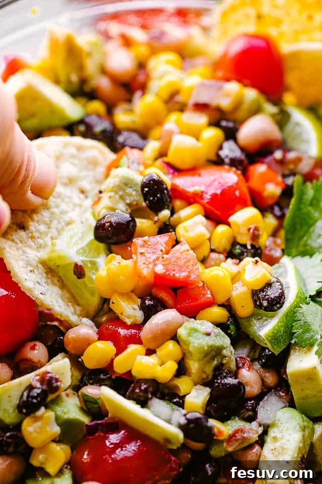 Scooping up fresh Cowboy Caviar with a tortilla chip