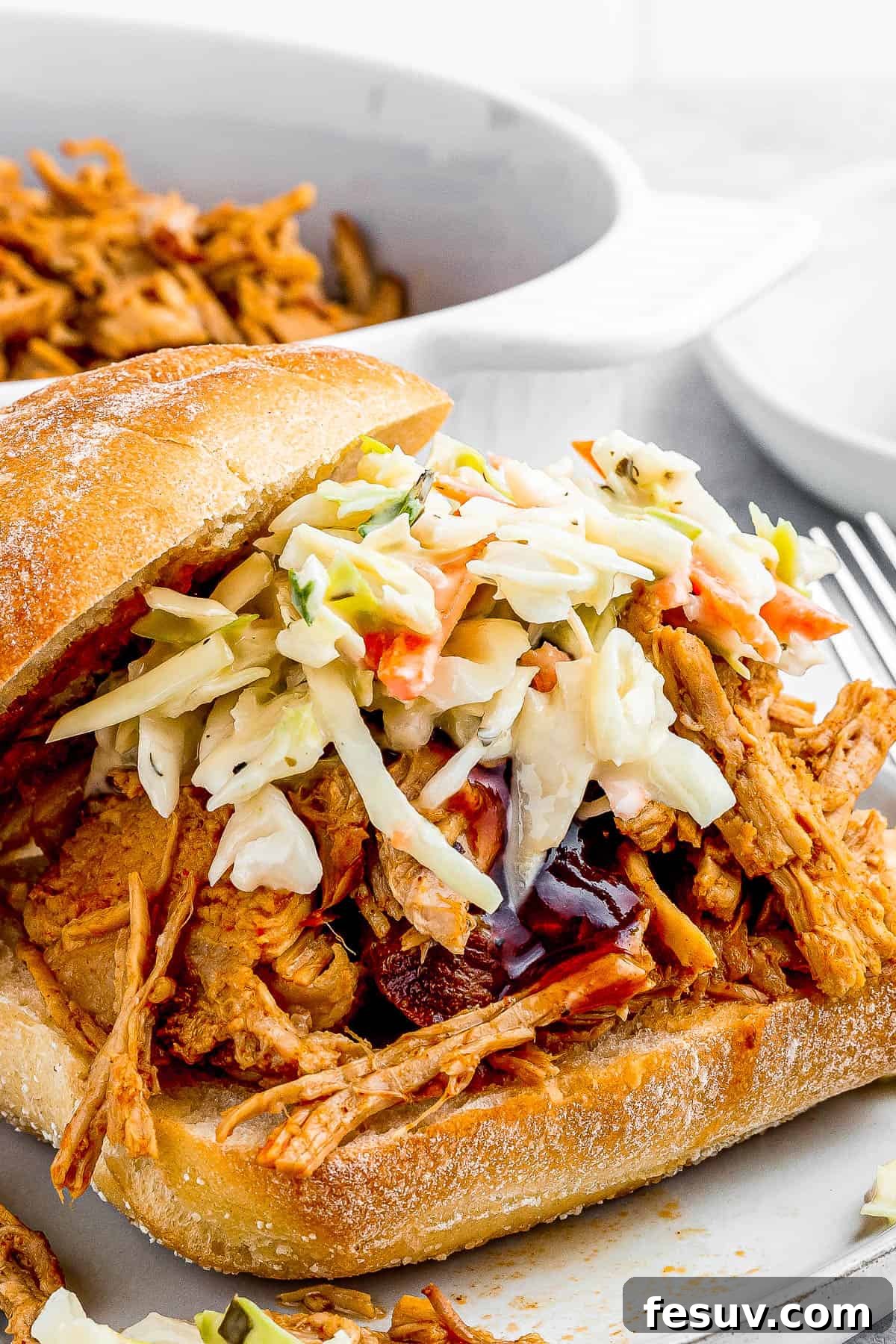 Effortless Instant Pot Pulled Pork with Zesty Coleslaw 8 Close-up of pulled pork sandwiches with coleslaw, ready on a wooden serving board