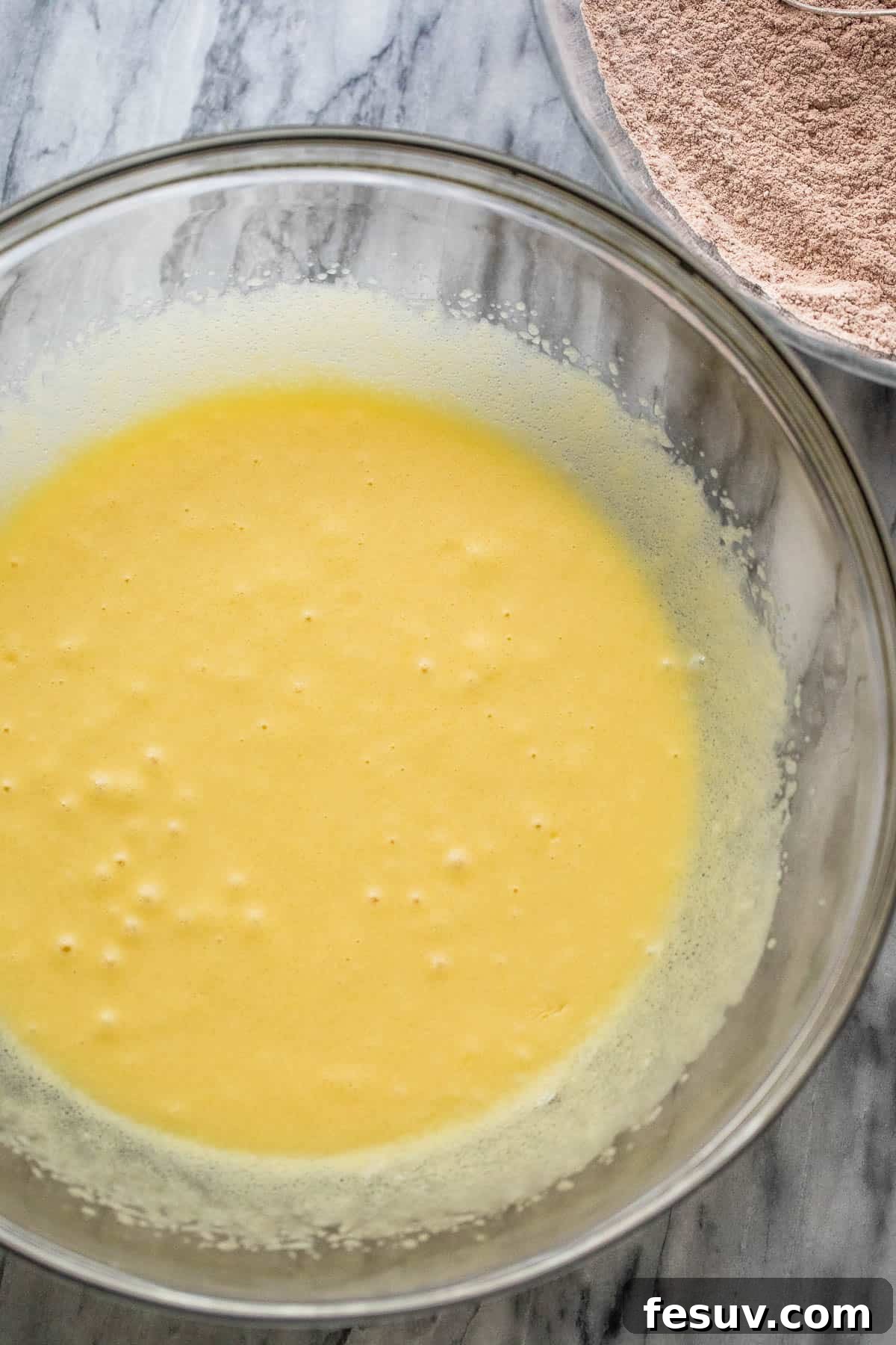 wet ingredients being mixed for chocolate zucchini bread batter