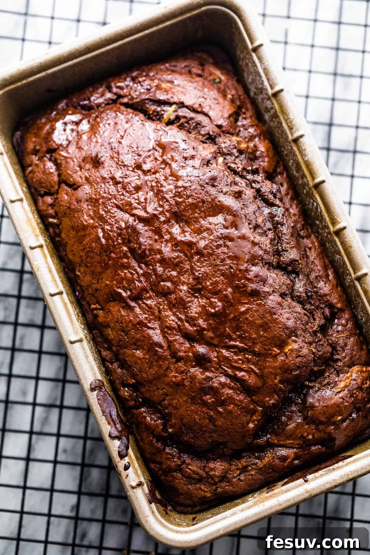 cooked chocolate zucchini bread cooling in a loaf pan