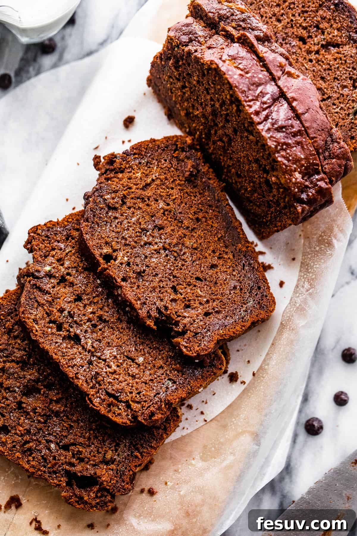 overhead shot of sliced chocolate zucchini bread with chocolate chips and a sea salt sprinkle