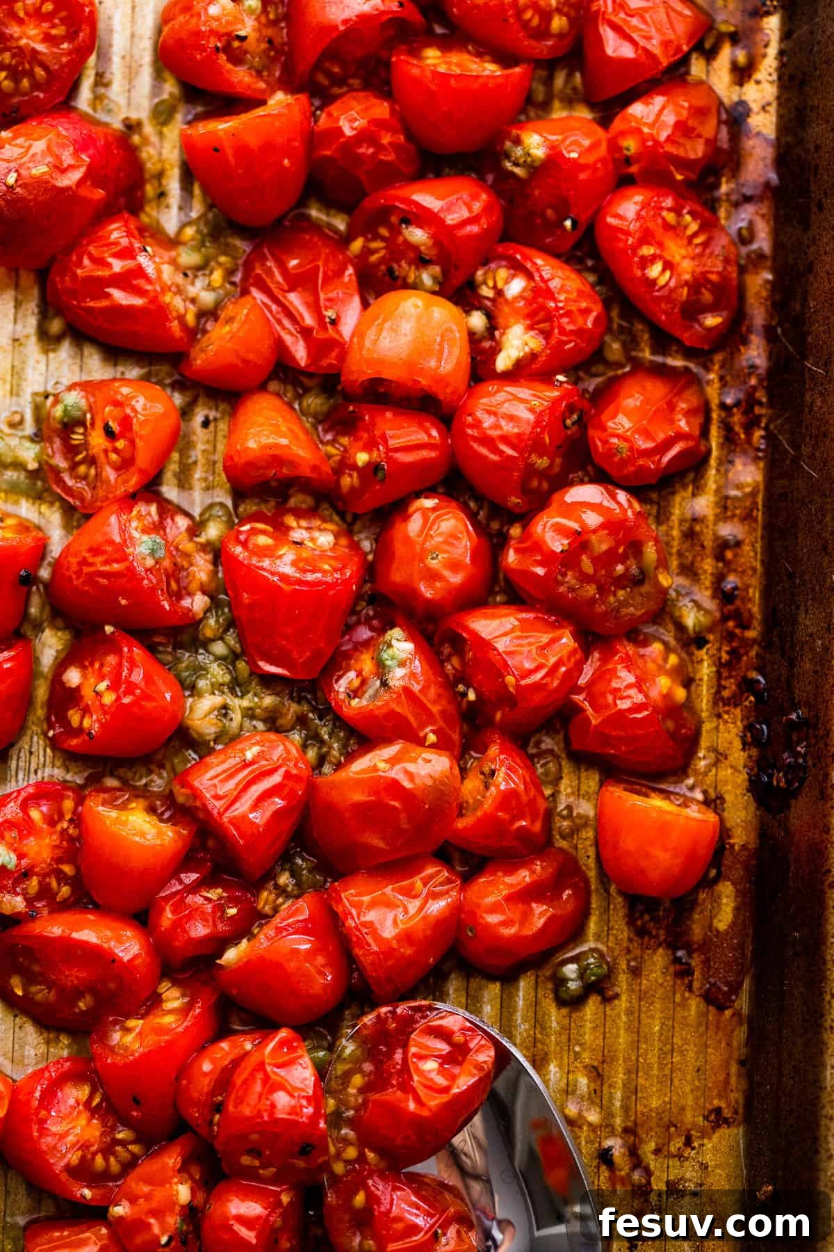 Blistered Tomato Tortellini 4 roasted cherry tomatoes on a baking sheet
