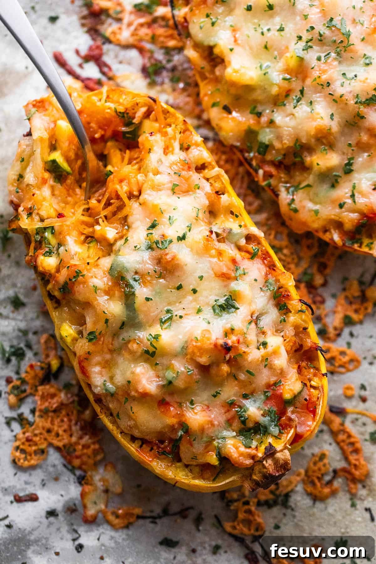 Spaghetti squash stuffed with chicken enchilada filling and topped with melted cheese, garnished with fresh cilantro.