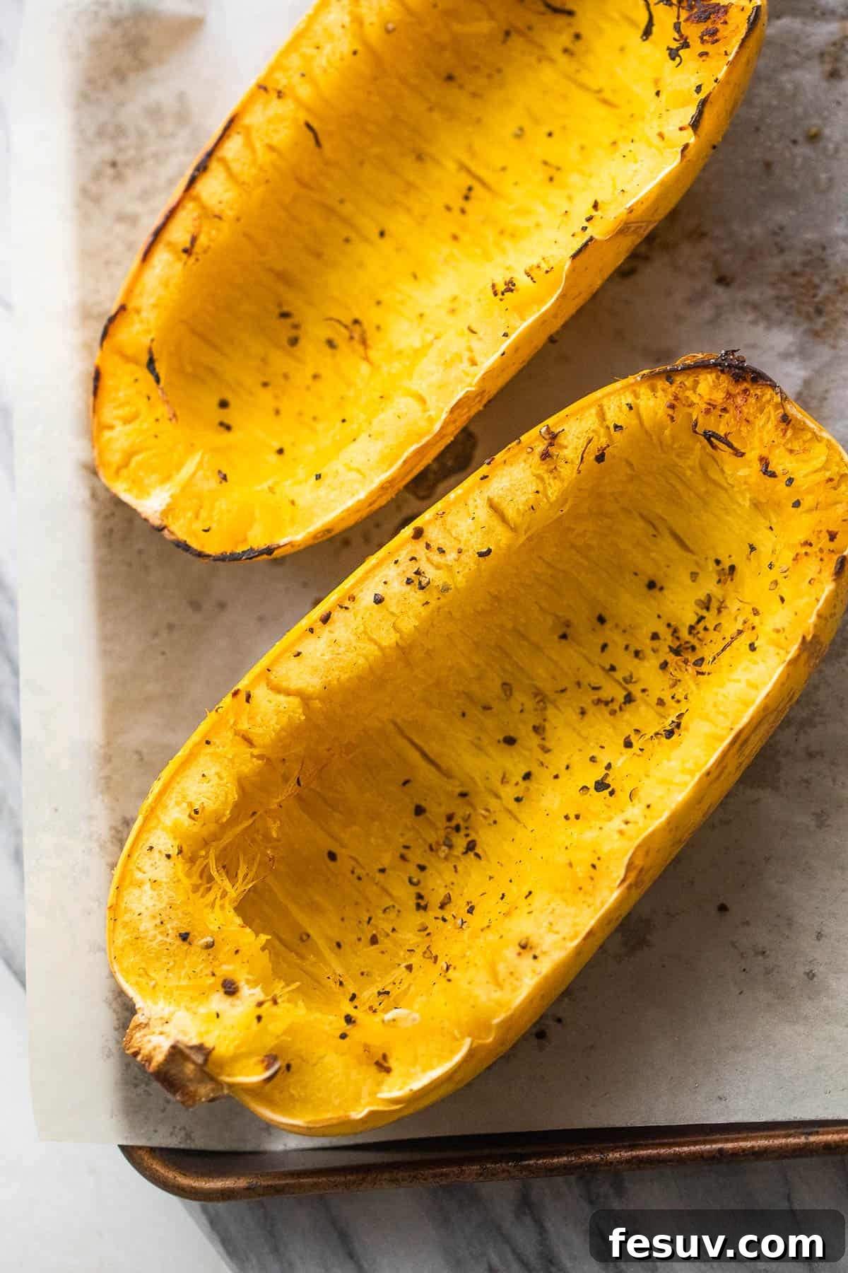 Halved spaghetti squash, ready for roasting.