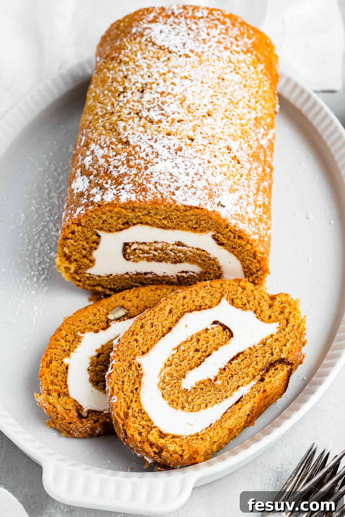 A pumpkin roll served on a platter.
