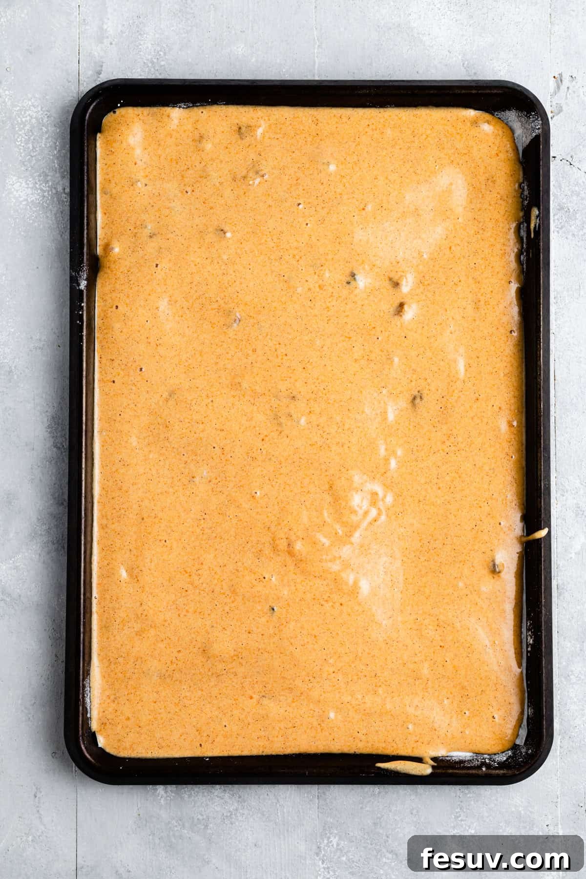 A cake batter in a baking pan.
