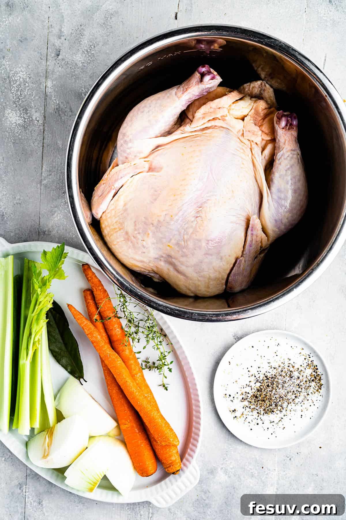 Homemade Instant Pot Chicken Broth 4 Clockwise from top: a whole chicken in a pot, a selection of seasonings, and a tray of raw vegetables including carrots, onions, and celery, ready for broth making.