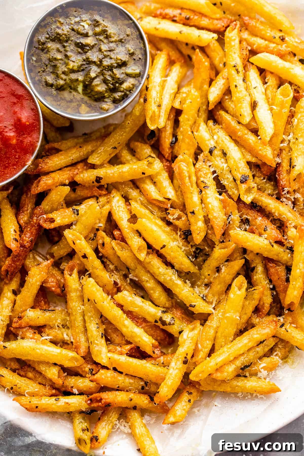Crispy Pasta Chips Air Fried or Oven Baked 2 plate with baked pasta chips served with a side of basil pesto and marinara sauce