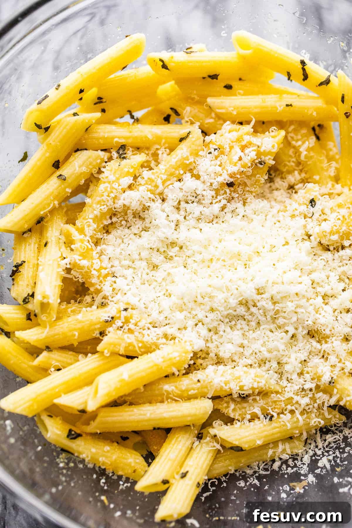 Crispy Pasta Chips Air Fried or Oven Baked 4 bowl with boiled pasta and a mount of parmesan cheese in the middle of it.