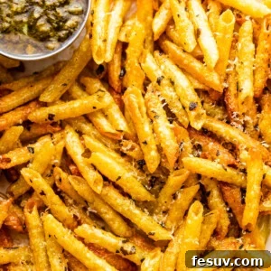 close up of baked pasta chips served with basil pesto