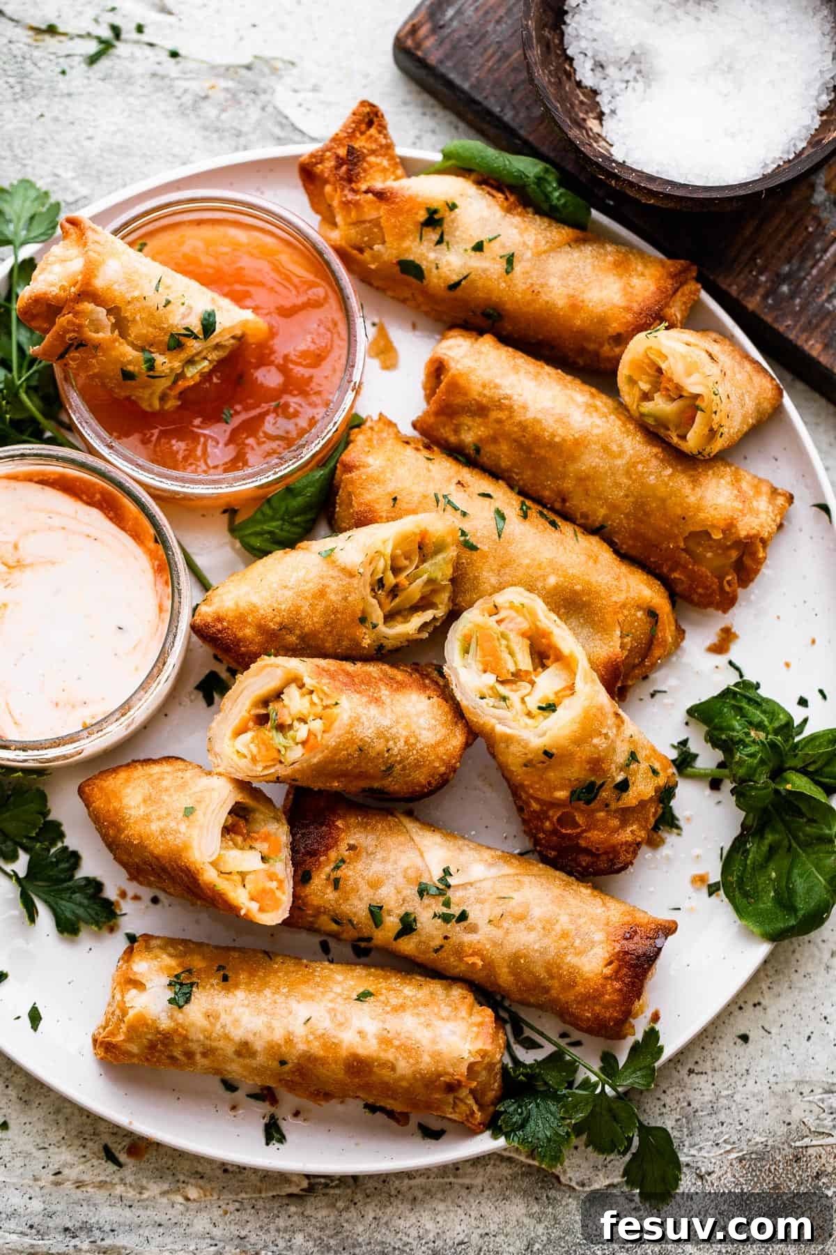 Sun-Kissed Vegetable Spring Rolls 2 A plate of golden-brown spring rolls with a side of dipping sauce, ready to be enjoyed.