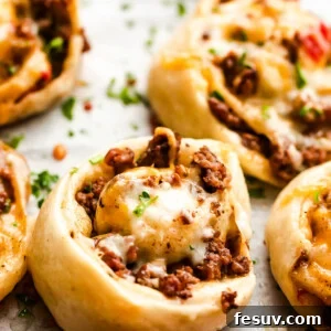 cooked taco pinwheels on a baking sheet.