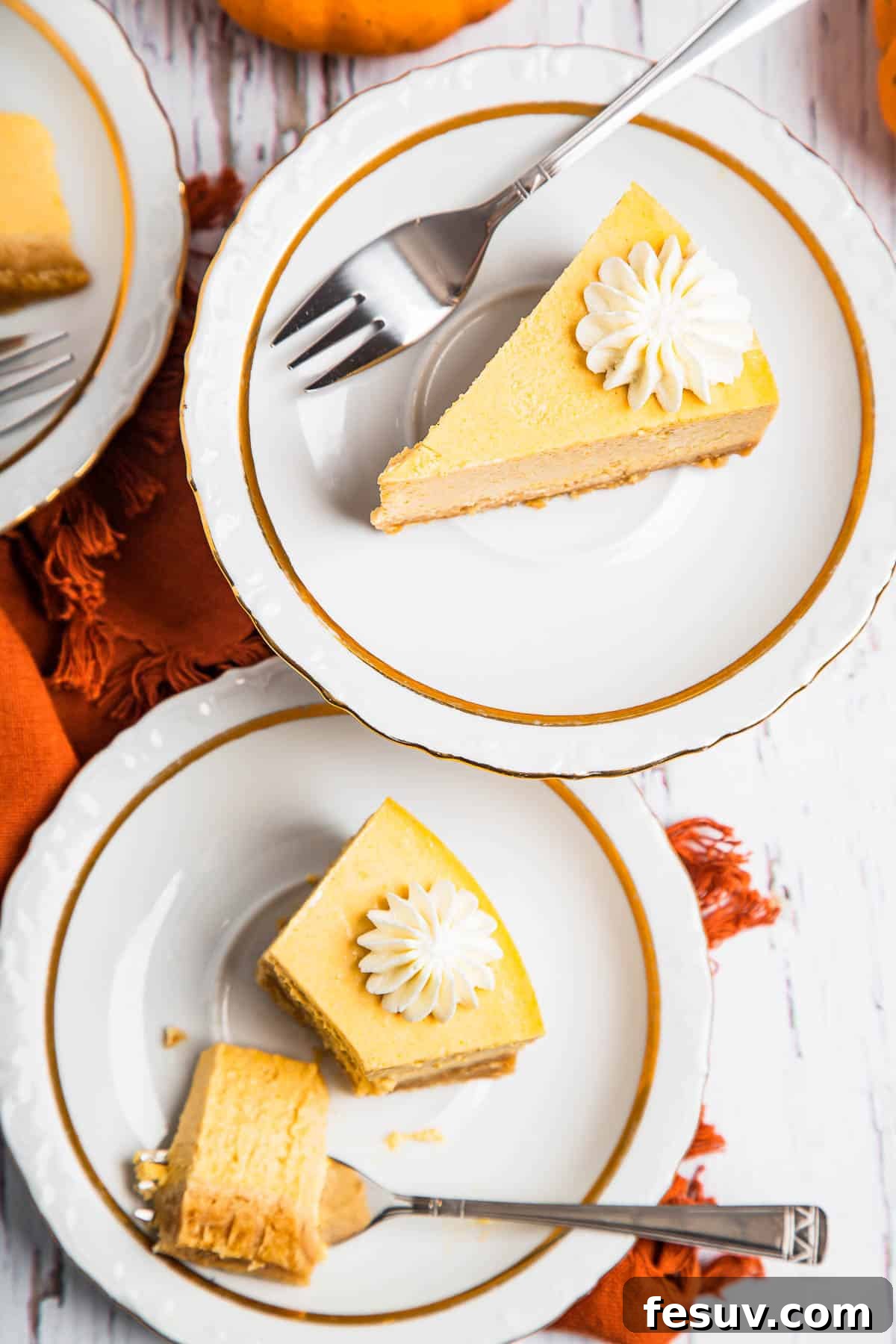 Creamy Instant Pot Pumpkin Cheesecake Bliss 7 An overhead shot of two plates, each holding a generous slice of Instant Pot Pumpkin Cheesecake, artfully presented.