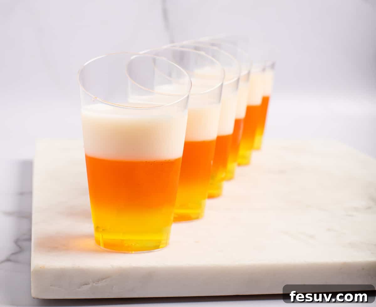 Vibrant Vodka Candy Corn Shooters 8 A row of matching candy corn jello shots.