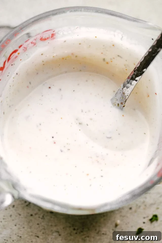 A mixing bowl filled with the creamy, homemade ranch dressing for Salmon BLT Salad.