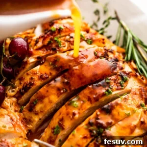 Perfectly Roasted Turkey Breast 7 pouring gravy over sliced turkey breast