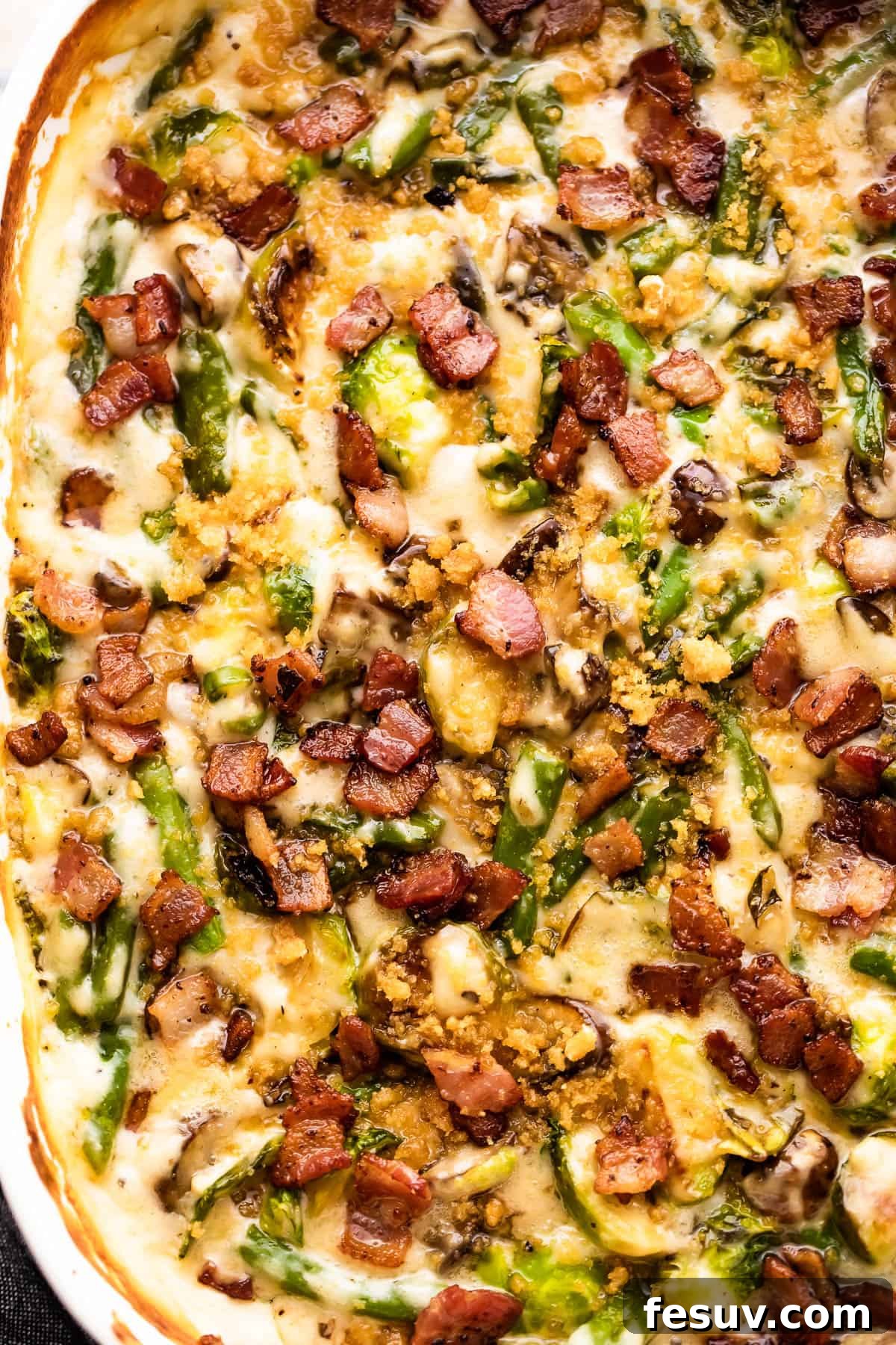 Delicious Green Bean Casserole with Crispy Bacon Topping A close-up shot of the finished green bean casserole, generously topped with golden crispy bacon bits, showcasing its rich texture and appetizing appearance.