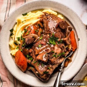 Instant Pot Coq au Vin: Classic French Flavor, Modern Speed 12 A serving of coq au vin with mashed potatoes on a stoneware plate.