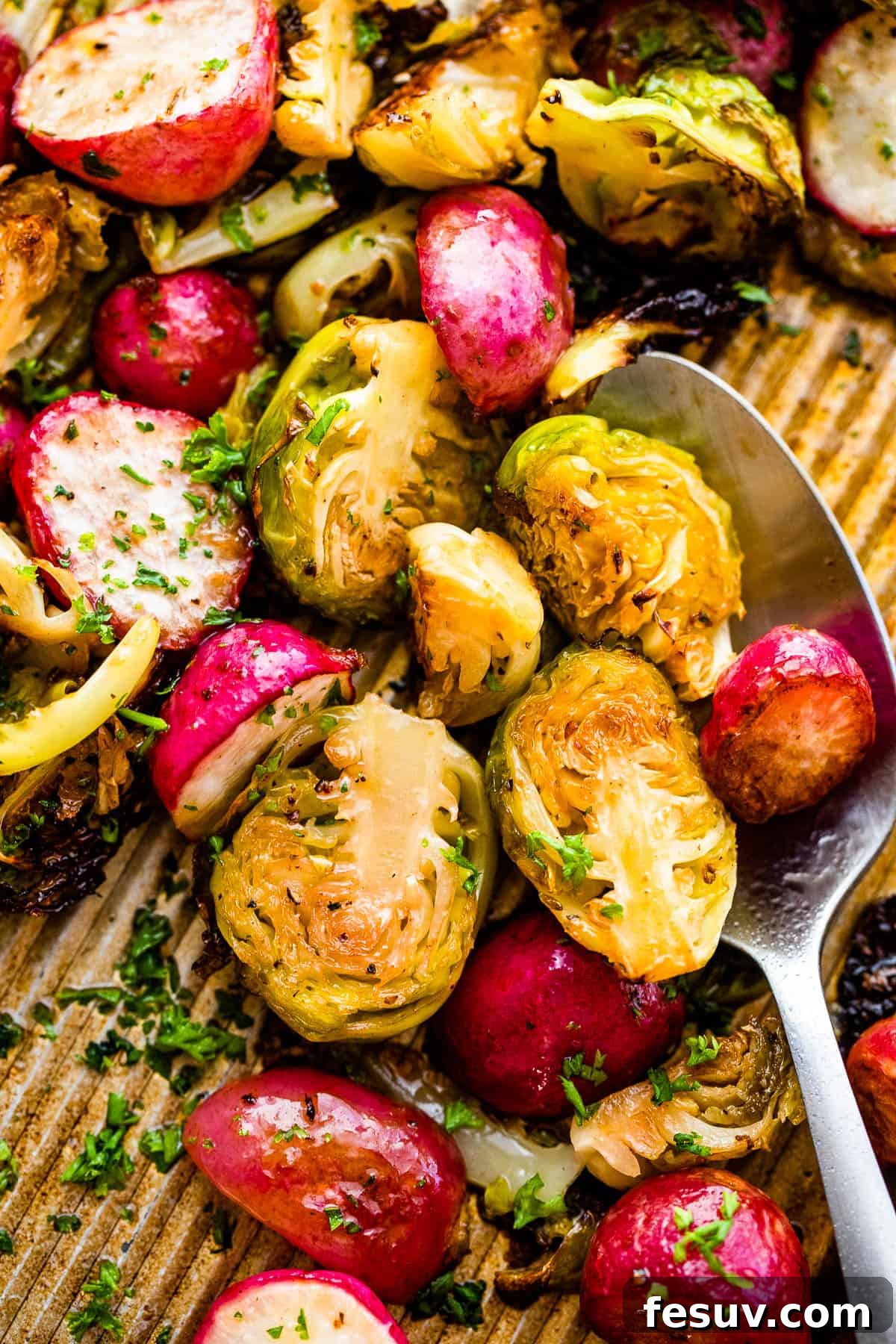 Crispy Roasted Brussels Sprouts and Radishes 3 Halved Roasted Brussels Sprouts and Radishes evenly spread on a baking sheet, ready for the oven.
