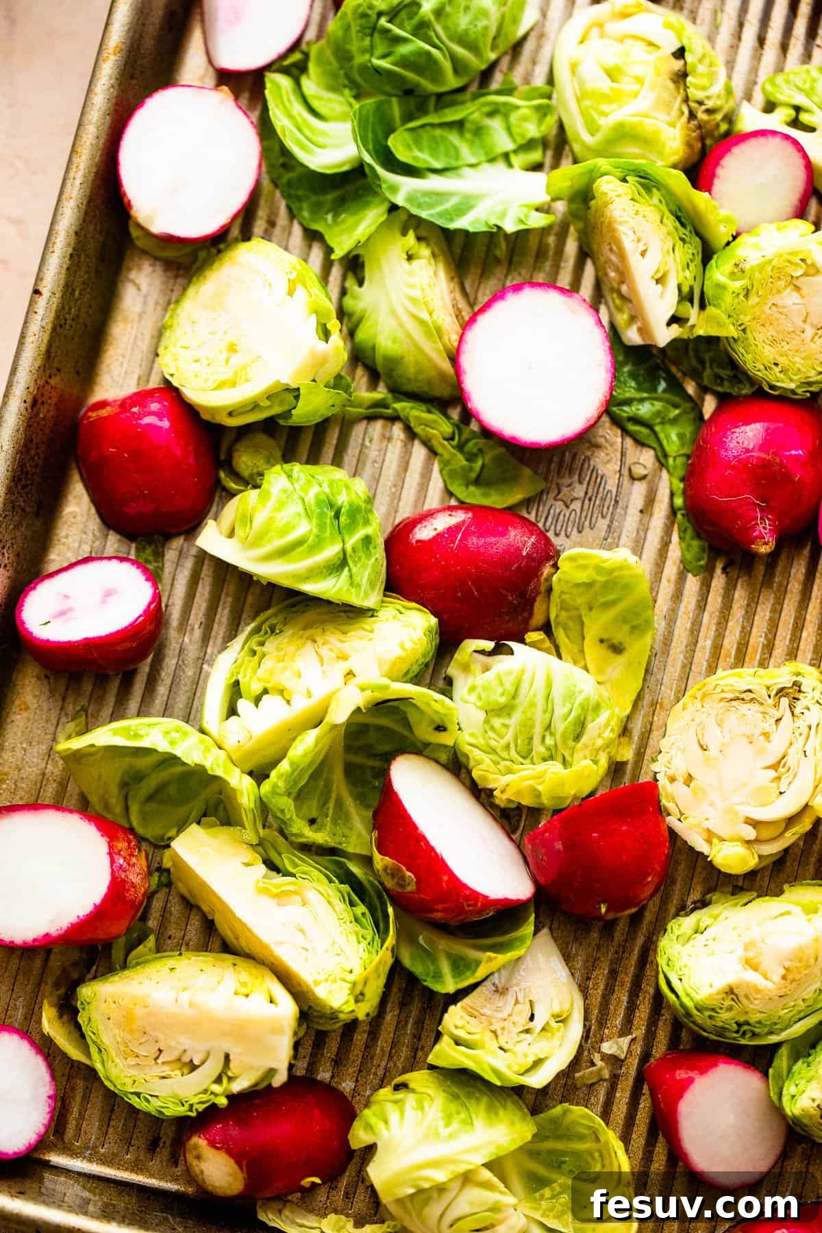 Crispy Roasted Brussels Sprouts and Radishes 4 Assortment of fresh Brussels Sprouts and radishes on a cutting board, ready for preparation.